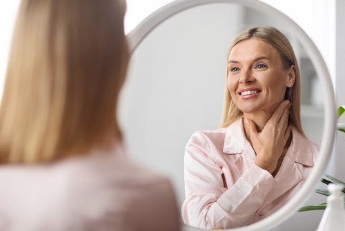 woman looking in mirror